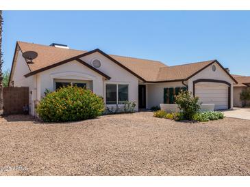Charming single-story home featuring well-maintained landscaping and a two-car garage at 10807 W Morten Ave, Glendale, AZ 85307