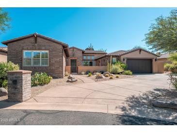 Inviting single-story brick and stucco home with desert landscaping and spacious driveway at 11070 E Bent Tree Dr, Scottsdale, AZ 85262