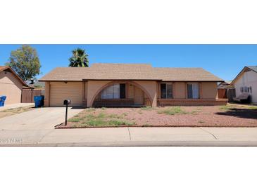 Charming single-story home features brick accents, attached garage, and low-maintenance landscaping at 1414 W Monona Dr, Phoenix, AZ 85027