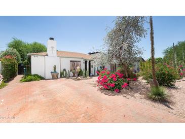 Charming home featuring brick driveway, desert landscaping, mature trees, and white exterior at 1441 E Hubbell St, Phoenix, AZ 85006