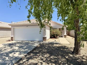 Charming single-story home with well-maintained front yard and attached two-car garage at 15706 W Young St, Surprise, AZ 85374