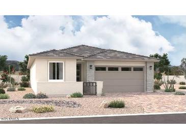 Charming single-story home featuring desert landscaping, a two-car garage, and neutral color palette at 15817 W Vogel Ave, Goodyear, AZ 85338