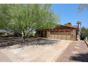 Charming home featuring a large, mature tree providing ample shade in the front yard at 1844 W Virginia Ave, Phoenix, AZ 85007