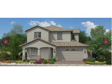Charming two-story home with a tile roof, neutral colors, landscaped yard, and an attached two car garage at 18751 W Monterosa St, Litchfield Park, AZ 85340