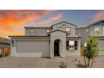 Charming two-story home with an attached two-car garage and desert landscaping against a vibrant sky at 3944 E Ghost Flower Ln, San Tan Valley, AZ 85140