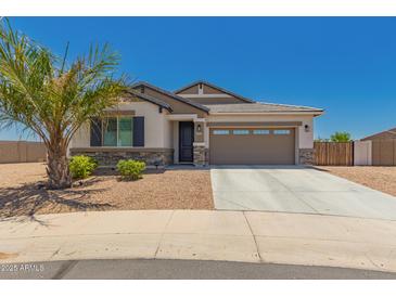 Beautiful single-story home featuring desert landscaping, stone accents and a spacious two-car garage at 40913 W Williams Way, Maricopa, AZ 85138