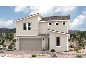 Modern two-story home featuring a neutral color scheme, attached two-car garage, and desert landscaping at 15823 W Vogel Ave, Goodyear, AZ 85338