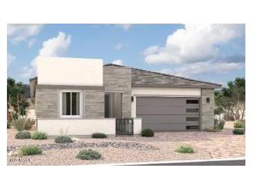 Modern single-story home featuring a two-car garage, stone veneer accents, and desert landscaping at 15872 W Miami St, Goodyear, AZ 85338