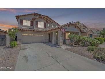 Charming two-story home features a covered porch, two car garage and desert landscaping at 16136 W Durango St, Goodyear, AZ 85338
