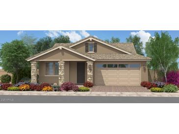 Charming single-story home with stone accents, a two-car garage, and beautifully landscaped front yard at 18747 W Monterosa St, Litchfield Park, AZ 85340