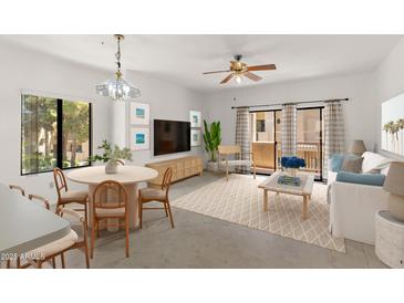Bright living room with dining area, neutral decor, ceiling fan, balcony access and lots of natural light at 19400 N Westbrook Pkwy # 220, Peoria, AZ 85382