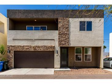 Modern two-story home featuring a two-car garage and tasteful stone accents at 2000 N 36Th St # 8, Phoenix, AZ 85008