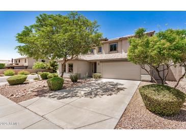 Charming two-story home with desert landscaping, mature trees, and a spacious driveway at 2746 E Fawn Dr, Phoenix, AZ 85042