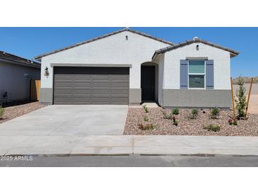 Charming single-story home featuring a two-car garage, low maintenance landscaping, and a welcoming entryway at 3550 N Camden Dr, Florence, AZ 85132