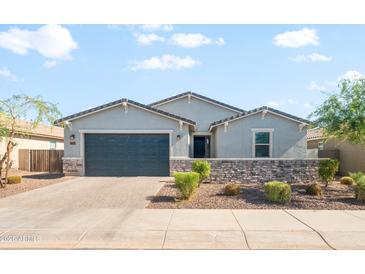 Charming single-story home featuring a neatly manicured yard and a stylish stone accent wall at 4143 E Sidesaddle Rd, San Tan Valley, AZ 85140