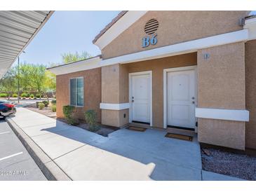 Condo featuring dual front doors, unit identifiers, and desert landscaping offering appealing curb appeal at 854 S San Marcos Bldg 6 -- # A, Apache Junction, AZ 85120