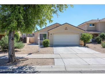 Charming single-level home featuring a two-car garage and well-maintained landscaping at 13959 W Country Gables Dr, Surprise, AZ 85379