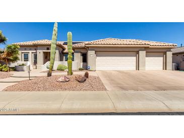 Charming single-story home with desert landscaping and a three-car garage at 20017 N Cielo Ct, Surprise, AZ 85374