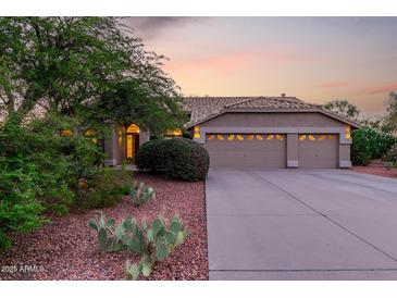 Charming single-story home featuring a three-car garage and desert landscaping at 29670 N 46Th St, Cave Creek, AZ 85331