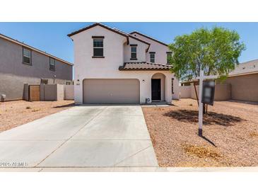 Charming two-story home with a two-car garage and well-maintained landscaping at 36025 W Santa Clara Ave, Maricopa, AZ 85138