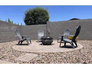 Outdoor fire pit with Adirondack chairs creates an inviting space for relaxation and gatherings at 500 W Nikita Dr, San Tan Valley, AZ 85140