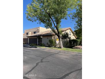 Beige two-story home featuring a tile roof and low-maintenance landscaping at 6223 N 12Th St # 1, Phoenix, AZ 85014