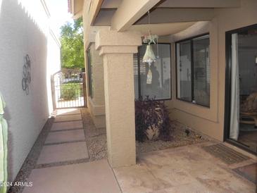Covered patio space with tiled floor and view of gated walkway at 9728 N 106Th Pl # 154, Scottsdale, AZ 85258