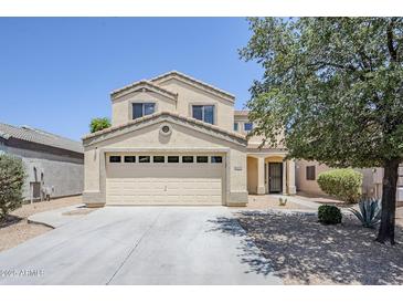 Inviting two-story home featuring a neutral color palette, desert landscaping, and attached two-car garage at 15205 N Honcho Ct, El Mirage, AZ 85335