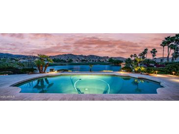 Beautiful backyard pool overlooking the golf course and lake at sunset at 16239 S 18Th Pl, Phoenix, AZ 85048