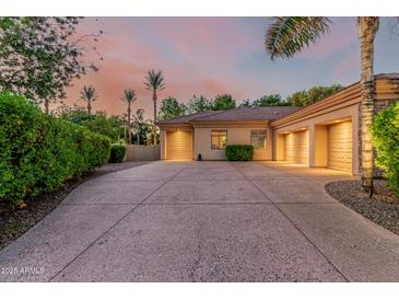 Well-maintained driveway leads to a three-car garage, surrounded by mature landscaping and a tile roof at 1758 E Carver Rd, Tempe, AZ 85284
