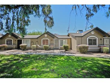 Inviting single story exterior featuring desert landscaping and an adorable covered entryway at 6711 W Osborn Rd # 82, Phoenix, AZ 85033