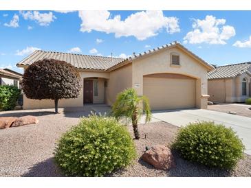 Charming single-story home featuring a two-car garage, neutral paint, desert landscaping and a lovely, sunny curb appeal at 17653 W Ingleside Dr, Surprise, AZ 85374