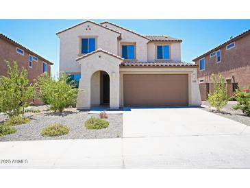 Charming two-story home featuring a stucco facade, tile roof, and a two-car garage at 19889 W Annika Dr, Litchfield Park, AZ 85340