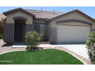Charming single-story home featuring a well-manicured lawn and a neutral color scheme at 46129 W Barbara Ln, Maricopa, AZ 85139