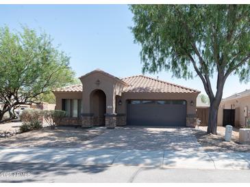 Charming single-story home with a desert landscape, paver driveway, and a two-car garage at 1381 E Prickly Pear Dr, Casa Grande, AZ 85122