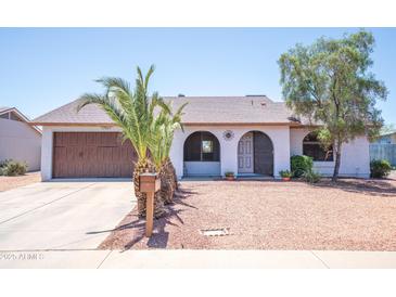 Charming single-story home with arched entry, desert landscaping, and a spacious two-car garage at 17810 N 34Th Pl, Phoenix, AZ 85032