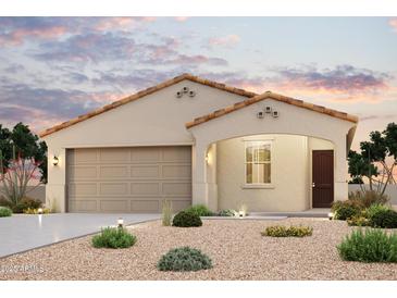 Charming single-story home featuring a neutral color palette, tile roof, and a well-manicured desert landscape at 24611 W Hilton Ave, Buckeye, AZ 85326