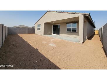 A spacious backyard featuring a covered patio and block fencing, providing privacy and outdoor living space at 3781 N Camden Dr, Florence, AZ 85132