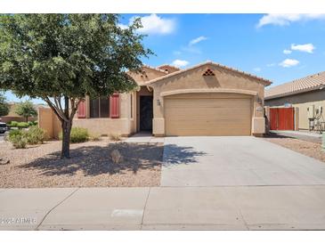 Inviting single-story home with a two-car garage and mature tree in a well-maintained front yard at 1380 W Angus Rd, San Tan Valley, AZ 85143