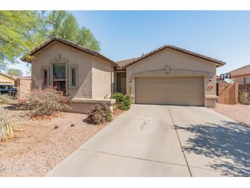 Charming single-story home featuring a low-maintenance desert landscape and a two-car garage at 17056 W Bristol Ln, Surprise, AZ 85374