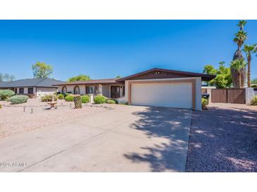 Charming single-story home featuring a two-car garage, desert landscaping, and a well-maintained front yard at 2446 E Hale St, Mesa, AZ 85213