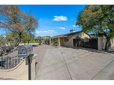 Charming single-story home with a well-kept front yard, featuring a spacious driveway and beautiful landscaping at 2601 N 51St St, Phoenix, AZ 85008