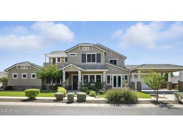 Charming home featuring a lush, green lawn and inviting curb appeal, perfect for Gathering living at 2822 E Constance Way, Phoenix, AZ 85042