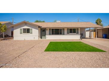 Charming single-story home with tidy desert landscaping and light colored exterior paint at 3209 N 20Th Pl, Phoenix, AZ 85016