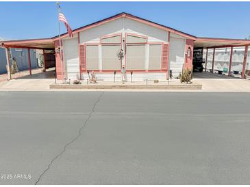 Charming single-story home featuring a covered carport, landscaped front yard, and decorative exterior details at 5735 E Mcdowell Rd # 436, Mesa, AZ 85215