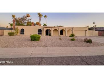 Attractive home with manicured desert landscaping, offering curb appeal and a welcoming entrance at 6639 E Pershing Ave, Scottsdale, AZ 85254