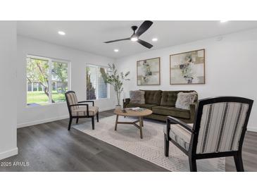 Stylish living room features a ceiling fan, art, and comfortable seating arrangement at 8329 E Keim Dr, Scottsdale, AZ 85250