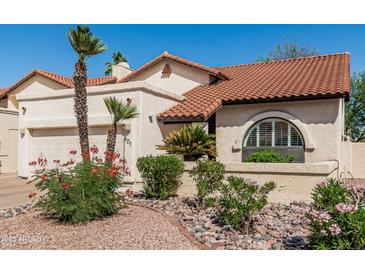 Charming single-story home features a desert landscape, red tile roof, and white stucco exterior at 401 E Barbara Dr, Tempe, AZ 85288