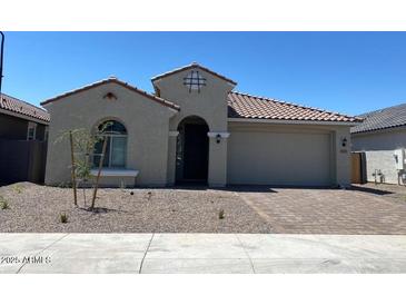 Charming single-story home with a low-maintenance landscaped front yard and a two car garage at 10217 W Fairmount Ave, Avondale, AZ 85392