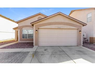 Charming single-story home featuring a two-car garage and landscaped front yard at 11829 W Rosewood Dr, El Mirage, AZ 85335